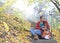 Meditative girl with her guitar in autumn