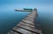 Meditative landscape with old wooden pier and wooden boats, long exposure