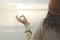 Meditative woman does relaxation exercises in front of the ocean