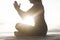 Meditative woman prays in front of the sea