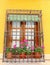 Mediterranean balcony with flowers and handicrafts curtains