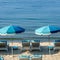 Mediterranean beach umbrella chairs relaxing sunbathing