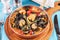 Mediterranean black pasta with shrimps, tomatoes, dumplings, rosemary and mushrooms