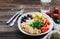 Mediterranean chicken quinoa bowl with cherry tomatoes, feta, olives and parsley