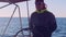MEDITERRANEAN - CIRCA NOVEMBER 2017: Yachtsman standing at wheel of yacht sailing in Mediterranean