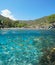 Mediterranean coast Spain beach in summer and fish shoal underwater