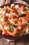 Mediterranean cuisine: shrimp Saganaki close-up on a plate. vert