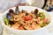 Mediterranean dish with calamari squids, clams and tomatoes
