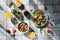 Mediterranean dishes at tiles table: vegetable and fruit salad, lemon and mint lemonade