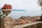 Mediterranean flowerpot on a post, view to garda lake over the r