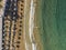 Mediterranean Greek beach aerial drone shot with unidentifiable bathers at Georgioupoli Crete island