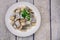 Mediterranean herring fillet served on a plate with parsley on the table