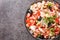 Mediterranean homemade cod salad with white beans, eggs and vegetables close-up in a bowl. horizontal top view