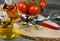 Mediterranean italian healthy food concept: isolated close up of olive oil bottles and silver spoon on wood cutting board with