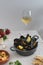 Mediterranean lunch, fresh cooked mussels with tomato, parsley, lemon, fresh bread and white wine