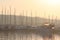 Mediterranean marina with sailing and motor yachts in the rays of the morning dawn. Sea touristic business. Infrastructure of the