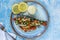Mediterranean sea bass stuffed with tomatoes, lemons, fennel and olives