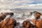 Mediterranean sea crashing onto rocks at Platja des Calo near Betlem and Colonia De Sant Pere with Cap De Formentor in the