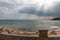 Mediterranean Sea in Northern Cyprus. Summer seashore with transparent blue water sun rays in the clouds. Seascape. Skyline