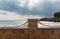 Mediterranean Sea in Northern Cyprus. Summer seashore with transparent blue water sun rays in the clouds. Seascape. Storm clouds