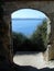 Mediterranean Sea Viewed Through Archway from Courtyard