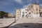 Mediterranean square with ancient buildings with television antennas. Italian traditional architecture. Bari town landmark.