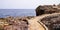 Mediterranean stones pathway in rocks access to beach sea in coast Juan-les-Pins in Antibes France in web header panoramic