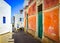 Mediterranean street with colorful walls and doors and windows