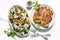 Mediterranean style lunch table - Greek chickpeas salad and pork chops on light background, top view