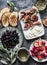 Mediterranean style snack appetizers - dried olives, figs, cheese, grilled bread, strawberries, raspberries and white wine on a