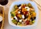 Mediterranean tuna salad with vegetables, olives, feta cheese and peach