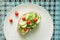 A Mediterranean twist on bruschetta with cream cheese, mint, cucumber and mini tomatoes on a graphic background.