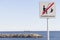 Mediterranean view and sign forbidden fish in catalan language,