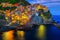 Mediterranean village with harbor at evening, Manarola, Cinque Terre, Italy