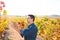 Mediterranean vineyard farmer checking grape leaves