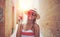 Mediterranean woman in hat holding tomato on street