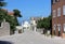 Mediterranian street view with the tiny church and mountains