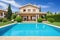 mediterrean house exterior with swimming pool and landscaped garden