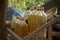 Medium close up of gasoline bottles on a wooden rack in rural Cambodia