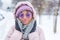 medium closeup shot of a young woman wearing warm clothes enjoying the cold winter day