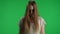 Medium green screen, chroma key shot of a posessed female, woman figure, ghost, poltergeist, zombie standing with her