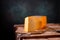 Medium hard cheese gouda edam on wooden board on sunlight table traditional table texture