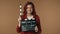 Medium isolated shot satisfied, happy and relaxed young woman holding an opened movie clicker, slate, clapperboard in