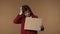 Medium isolated video of a sad young woman holding a piece of cardboard that says \'need job\' in her hands