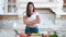 Medium long shot smiling woman cooking standing in kitchen with crossed hands