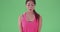 Medium of a millennial Asian woman lifting a kettle bell on green screen