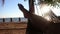 Medium POV perspective person crosses legs while swinging gently in a hammock by the sea