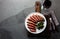 Medium rare beef steak on white plate, glass of red wine