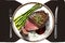 Medium rare grilled Tomahawk beef steak with asparagus.