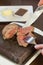 Medium rare steak sizzling on hot stone plate being sliced